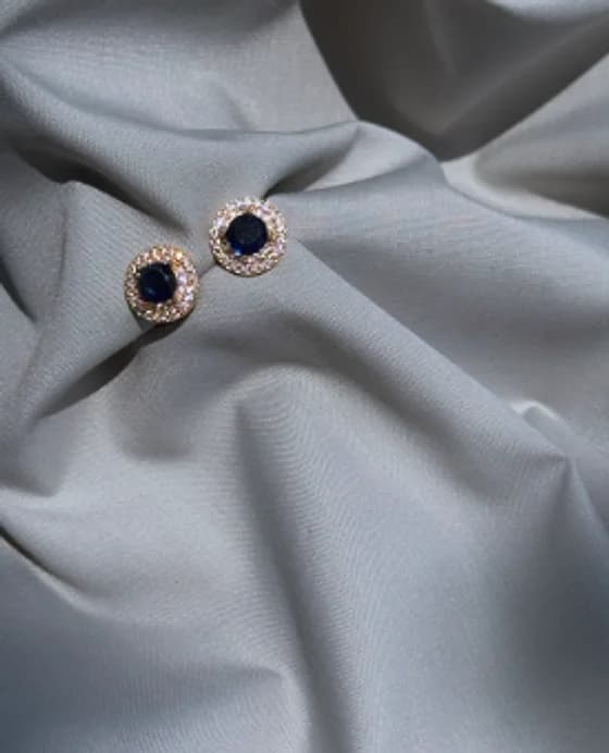 Deep blue stud earrings with a crystal halo
